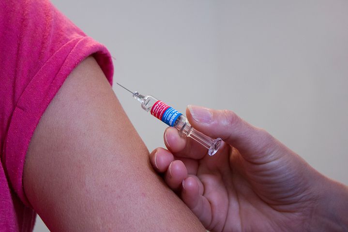 Woman getting corporate flu vaccination vouchers